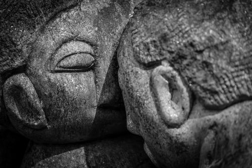 Free Detailed view of ancient carved stone faces, conveying timeless artistry and historic significance. Stock Photo