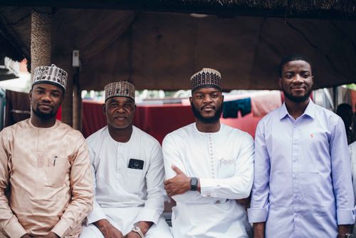 Free A diverse group of men in traditional and modern clothing posing confidently indoors. Stock Photo