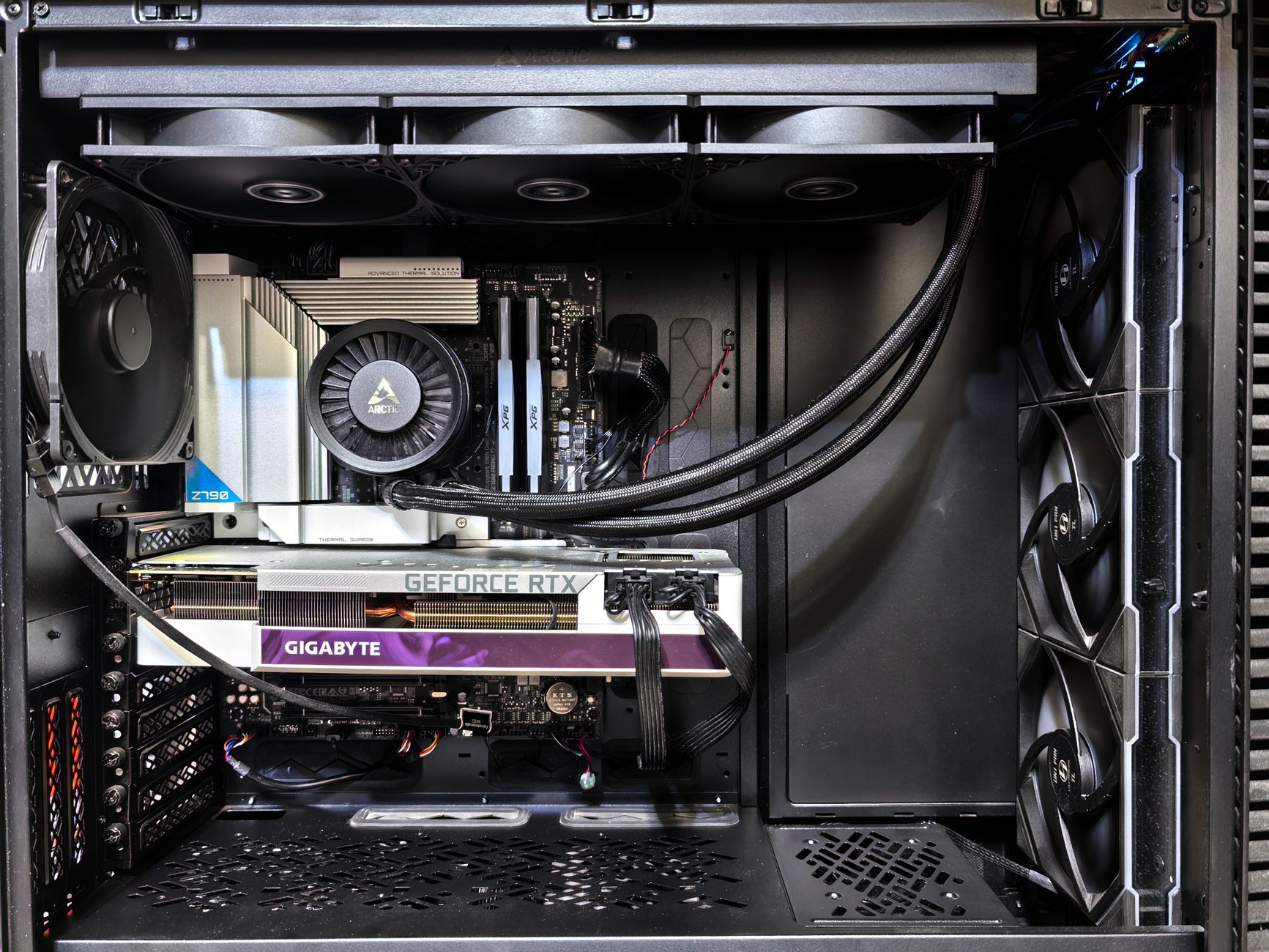Interior view of a gaming PC showcasing a GeForce RTX graphics card and high-performance cooling system.