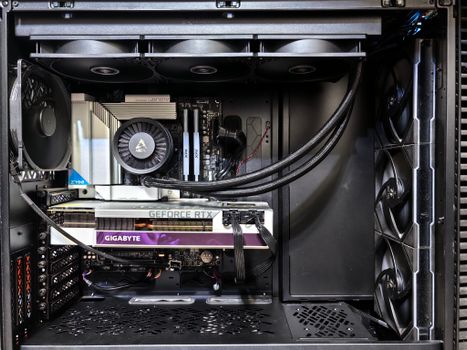 Interior view of a gaming PC showcasing a GeForce RTX graphics card and high-performance cooling system.