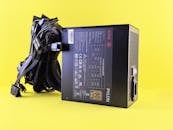 PC Power Supply Unit with Cables on Yellow Background