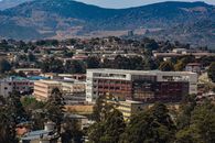 Aerial view of Manzini, Eswatini, showcasing urban development amidst rolling hills.