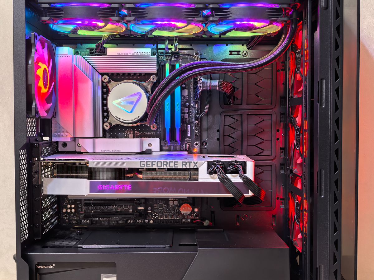 RGB-lit gaming PC interior with a white GeForce RTX graphics card installed