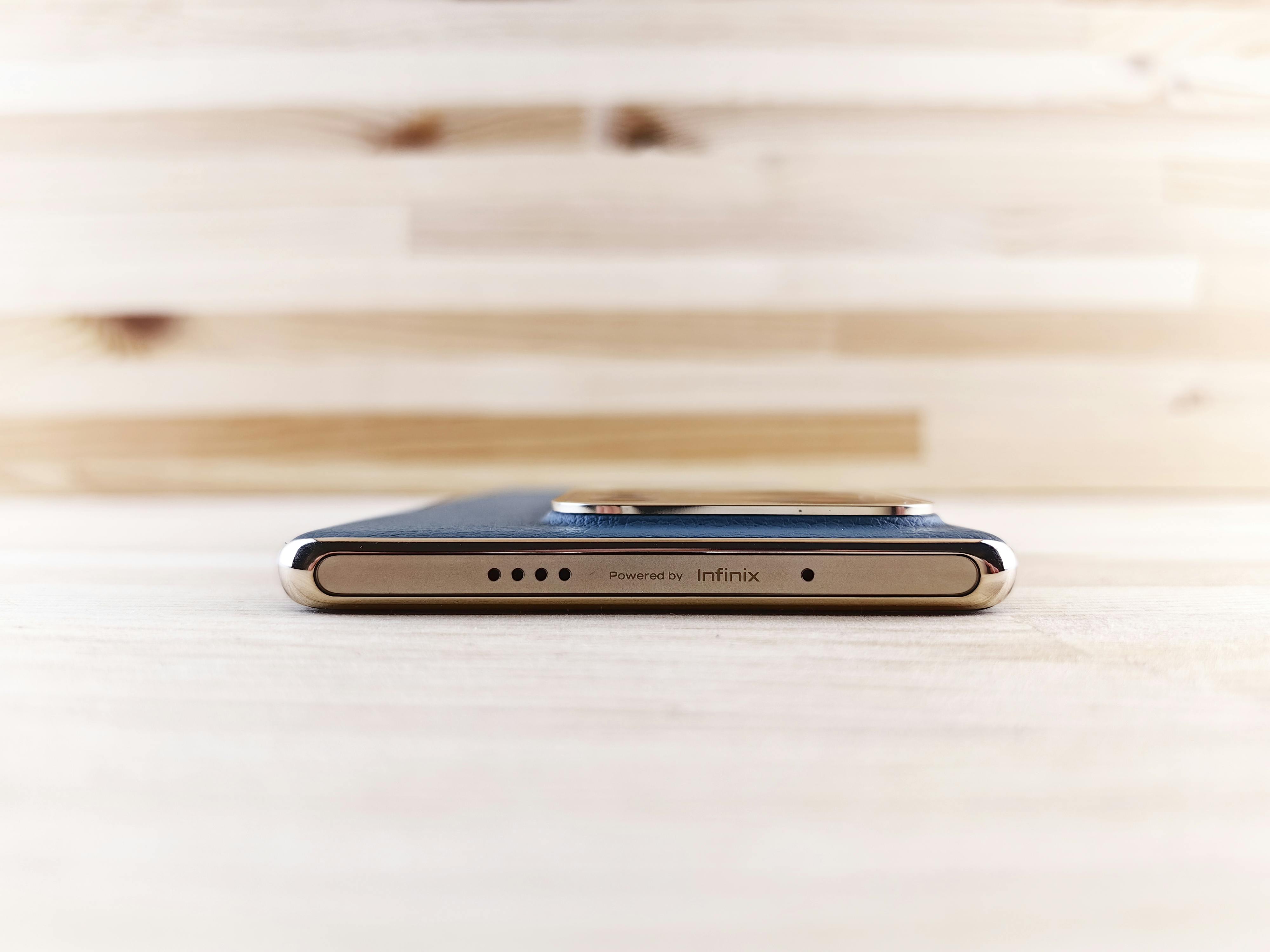 A premium portable power station placed on a rustic wooden table at a campsite
