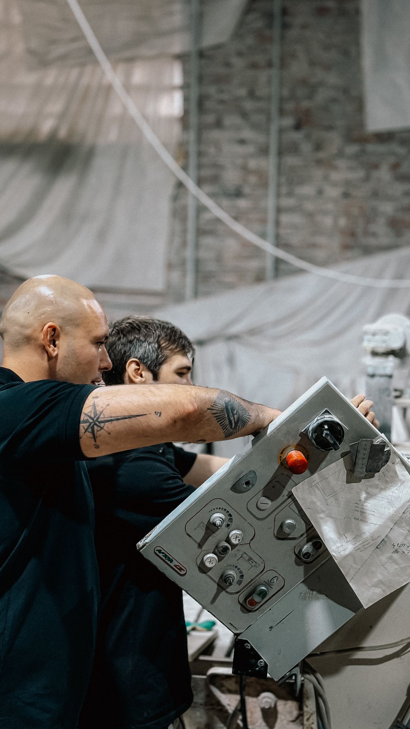 Industrial workers operating machinery together