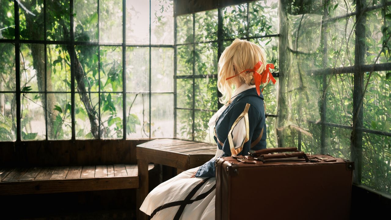 cosplay character in vintage outfit with suitcase in rustic wooden roo