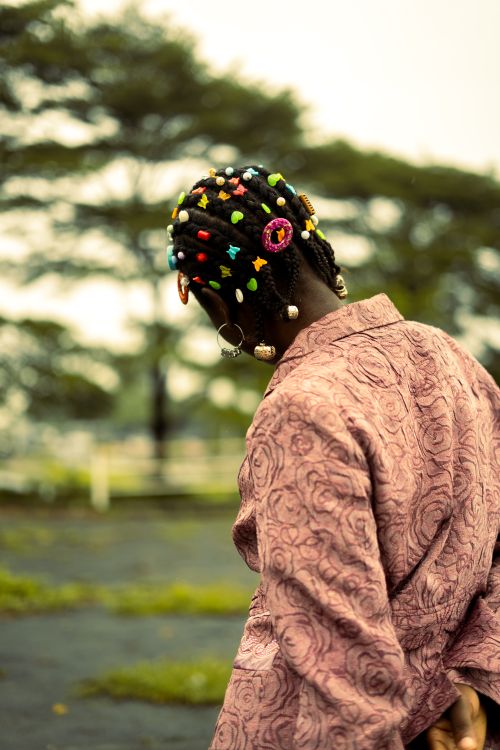 Free Back view of a person with colorful hair accessories outdoors. Stock Photo