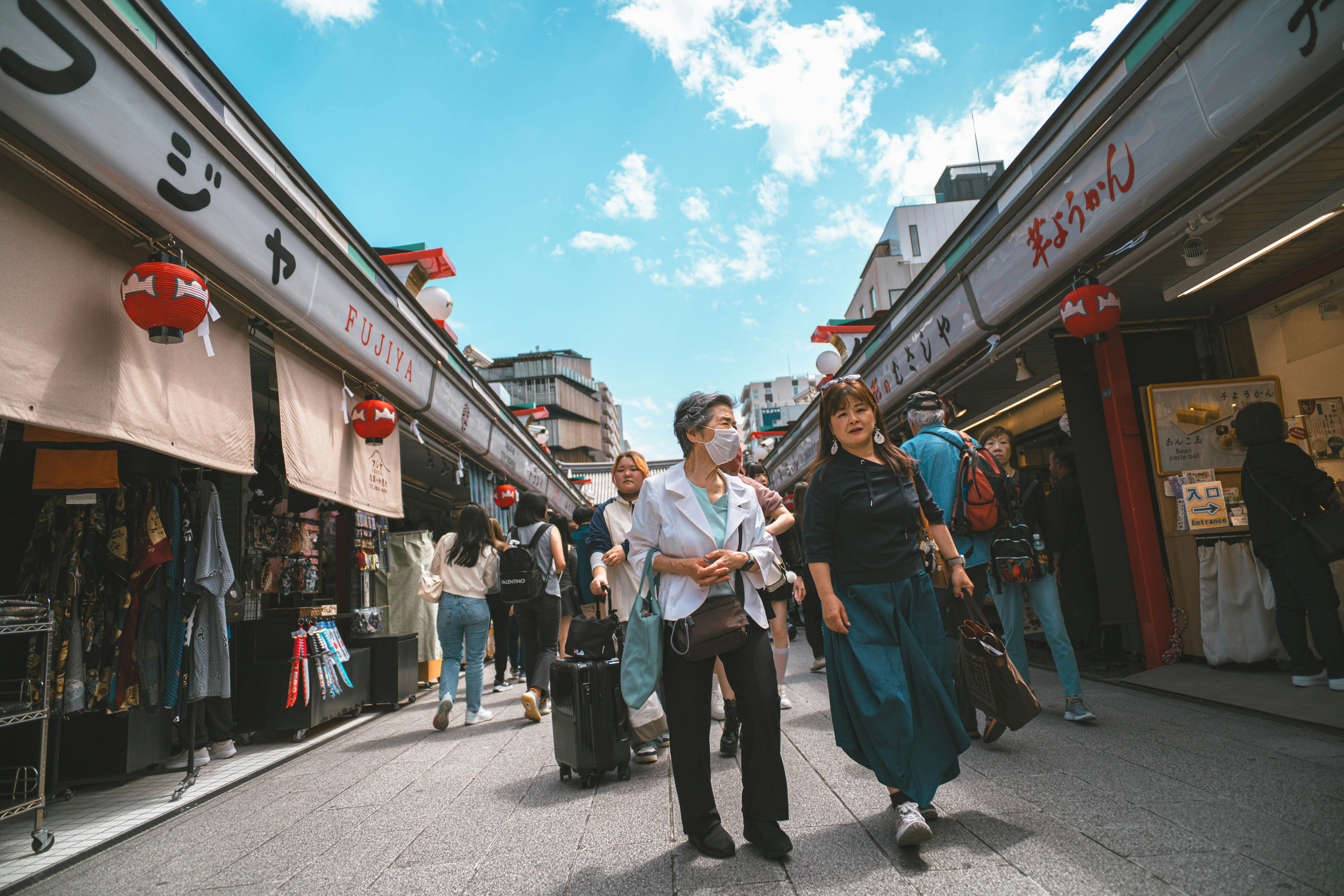 Explore a bustling shopping street in Tokyo, capturing the essence of Japanese culture and daily life.
