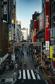 Bustling street scene in Shinjuku, Tokyo, capturing the vibrant city life and iconic architecture.