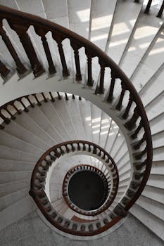A captivating view of a spiral staircase in Faisalabad, showcasing elegant design and wooden architecture.