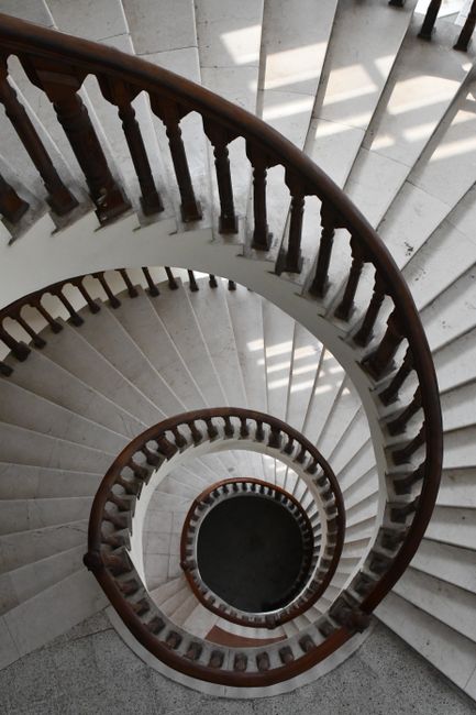 A captivating view of a spiral staircase in Faisalabad, showcasing elegant design and wooden architecture.