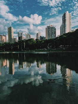 High-rise buildings reflected in a calm river at Setor Bueno, Brazil.