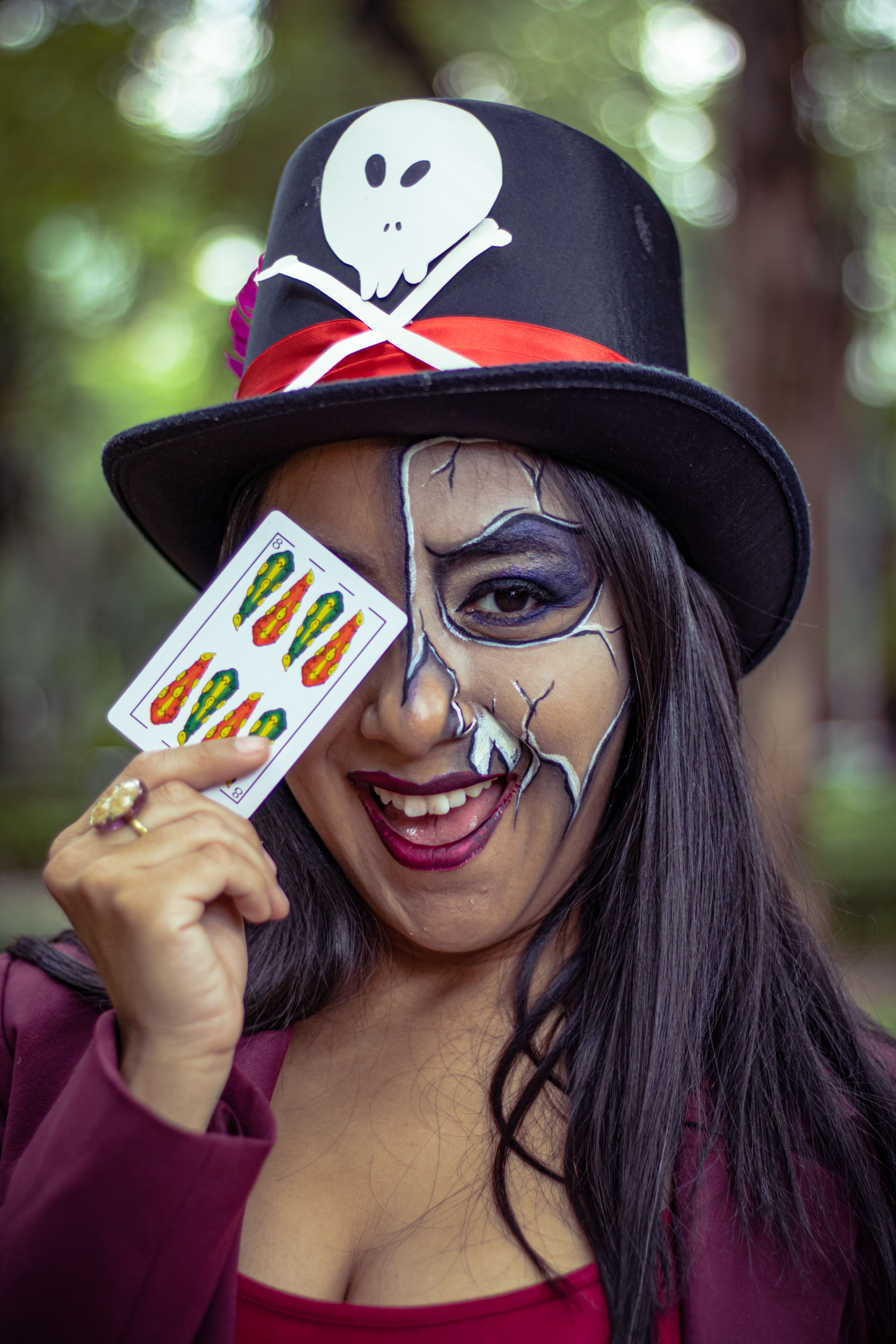 Artistic makeup and vibrant cosplay performance captured outdoors in a Mexico City park.