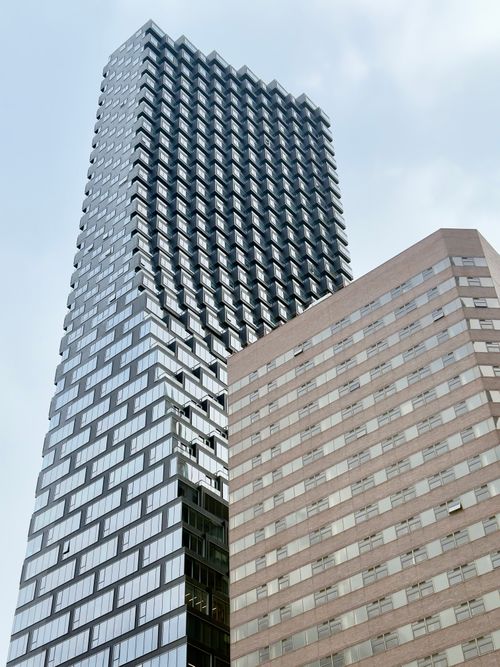 Free View of two contrasting modern skyscrapers against a clear sky in Calgary, AB. Stock Photo