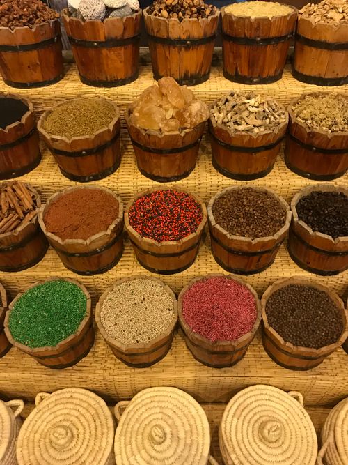 Free Vibrant display of various spices in wooden barrels at a market, showcasing natural textures and colors. Stock Photo