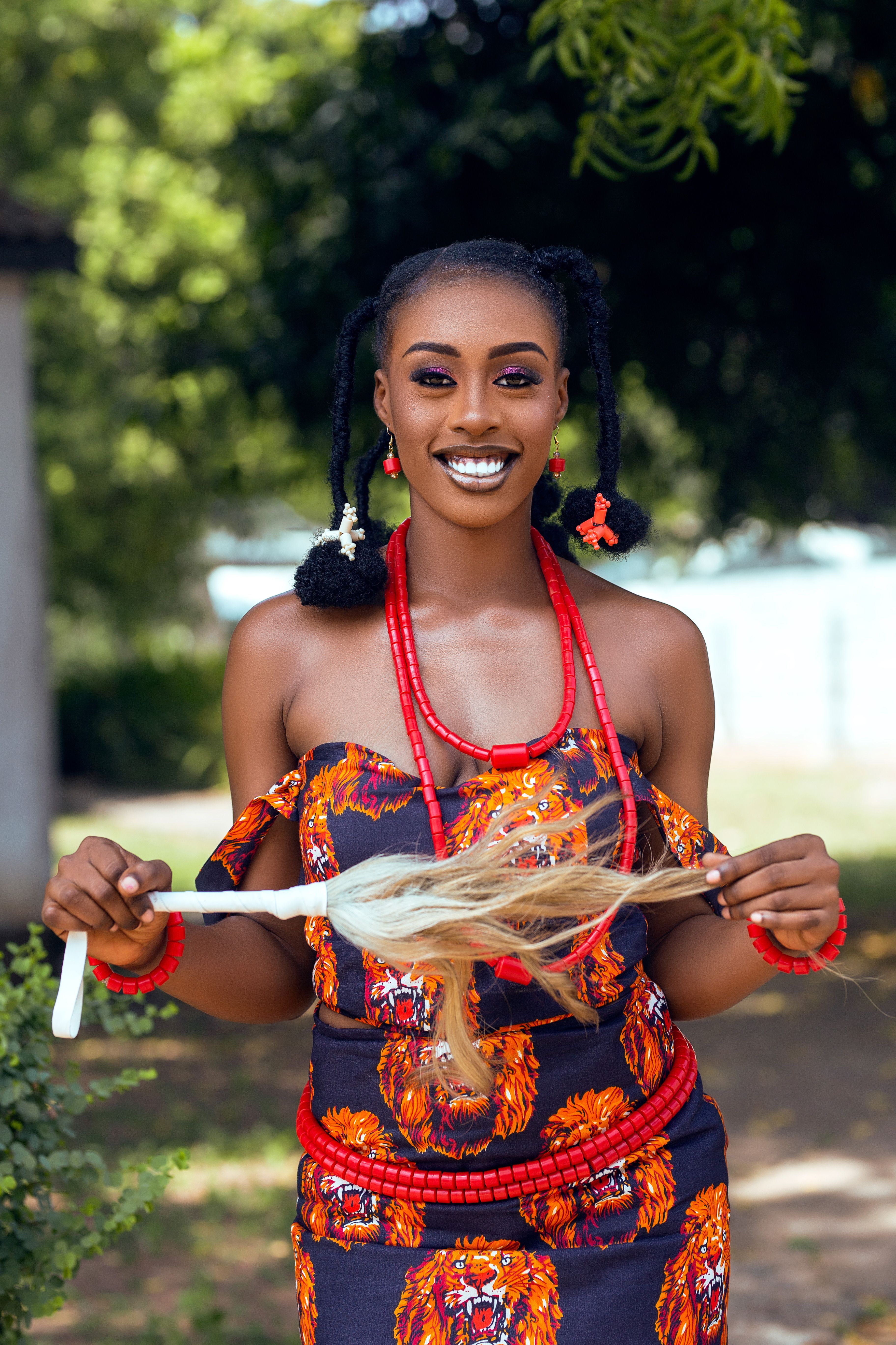 Young woman in traditional African clothing and jewelry during cultural festival in Accra, Ghana.