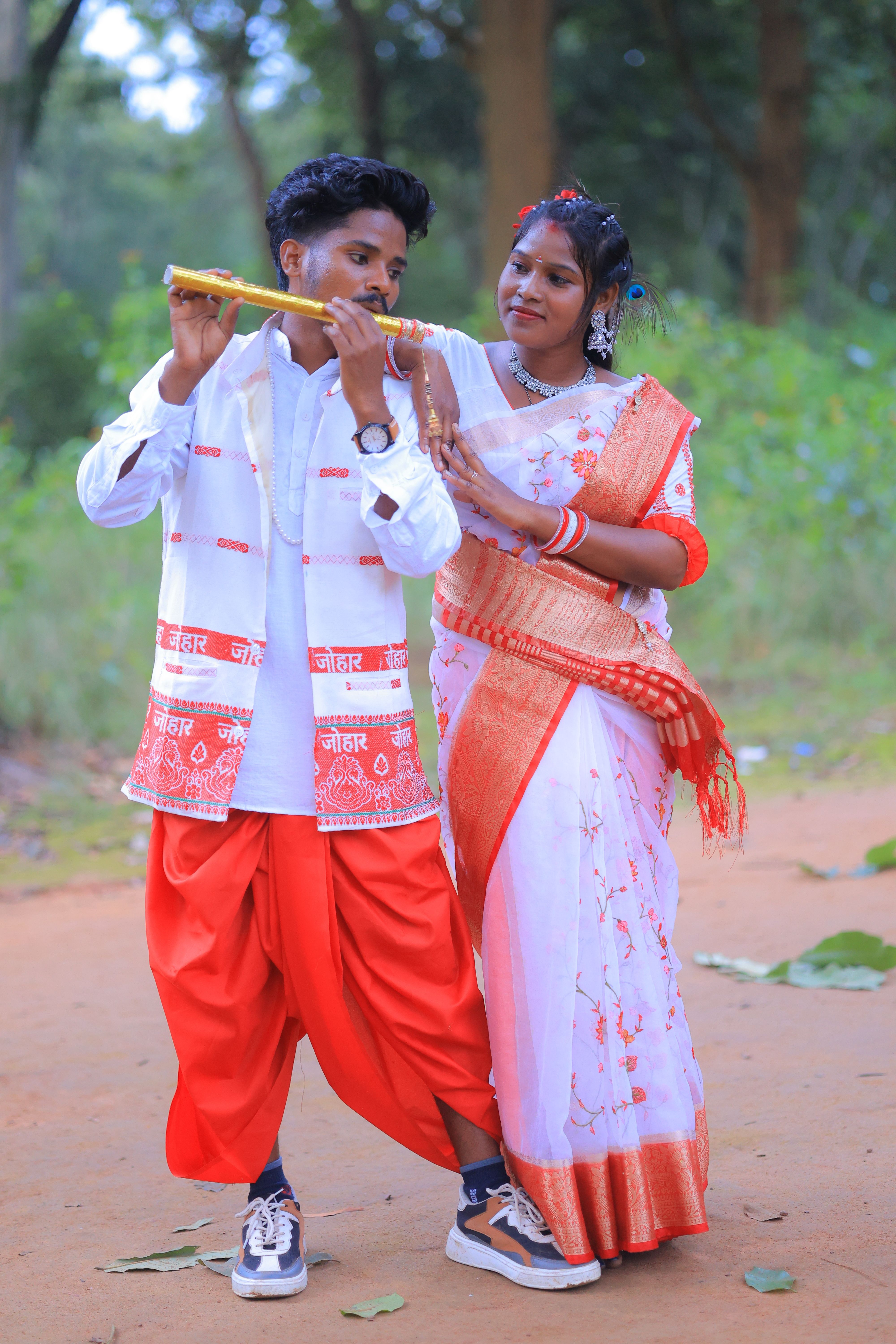 A couple dressed in traditional clothing enjoying music outdoors, creating a lively scene.