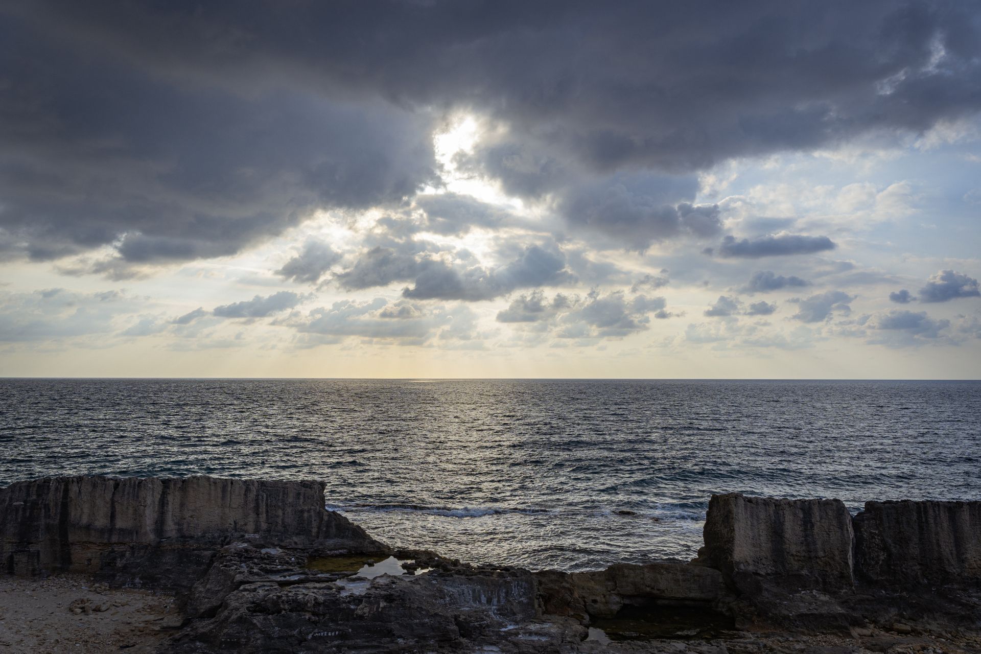 Calm Mediterranean coastline and horizon at dusk