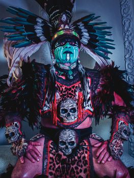 Captivating portrait of an Aztec warrior in full ceremonial attire with vibrant face paint and feathered headdress. - Fotografer Sidoarjo
