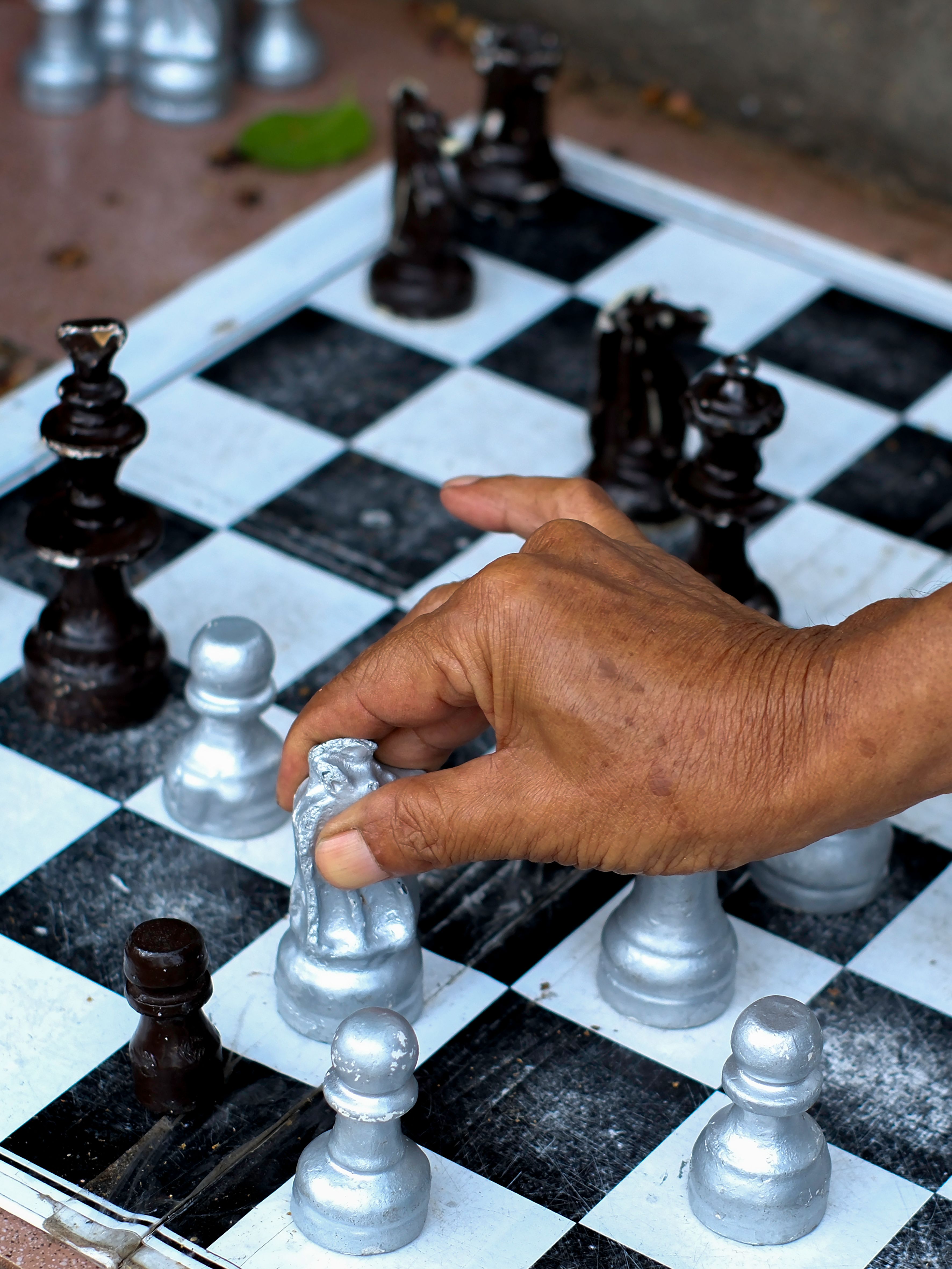 Close-up of Hand Moving Chess Piece on Board · Free Stock Photo
