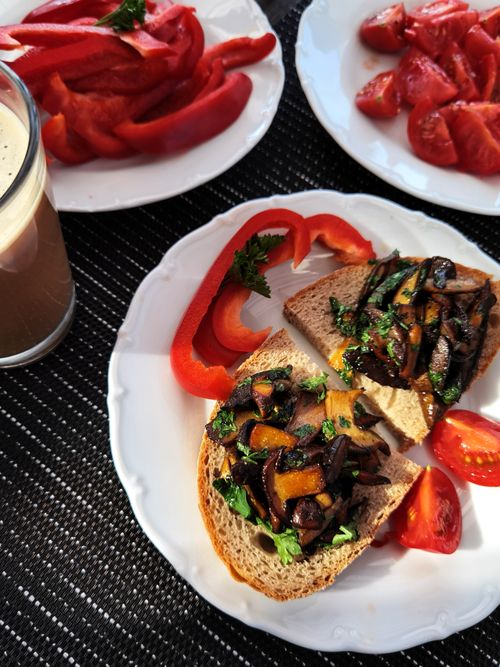 Free Tasty bruschetta topped with sautéed vegetables served with coffee and fresh tomatoes. Stock Photo