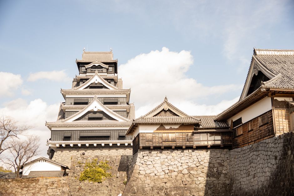 Beautiful view of historic Kumamoto Castle in Japan on a sunny day.