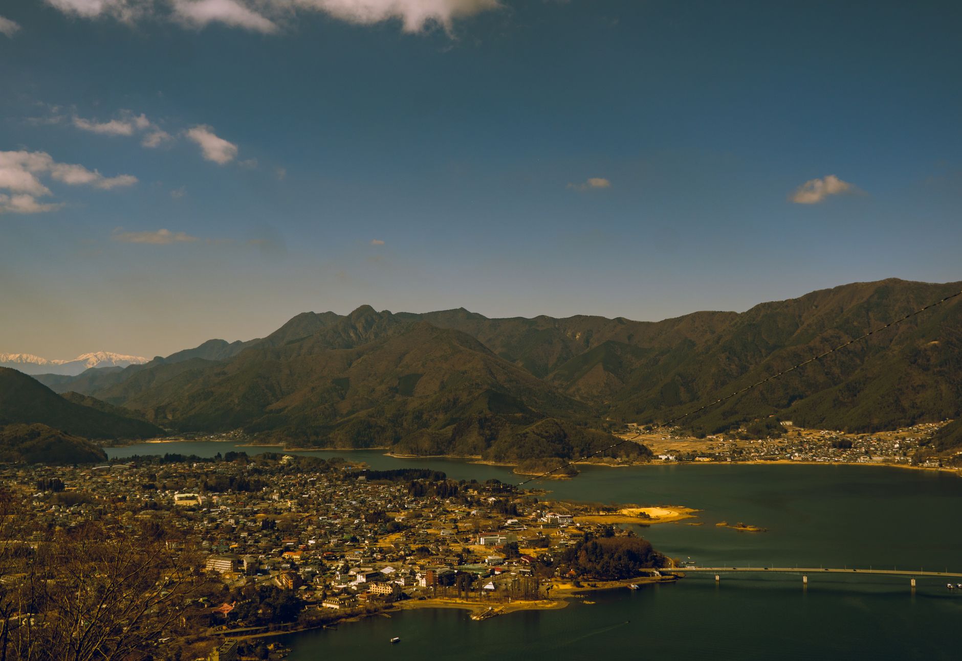 Breathtaking aerial perspective of Lake Kawaguchi surrounded by mountains in Japan.
