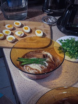 Delicious homemade ramen in a warm broth with boiled eggs and vegetables, perfect for comfort food lovers.