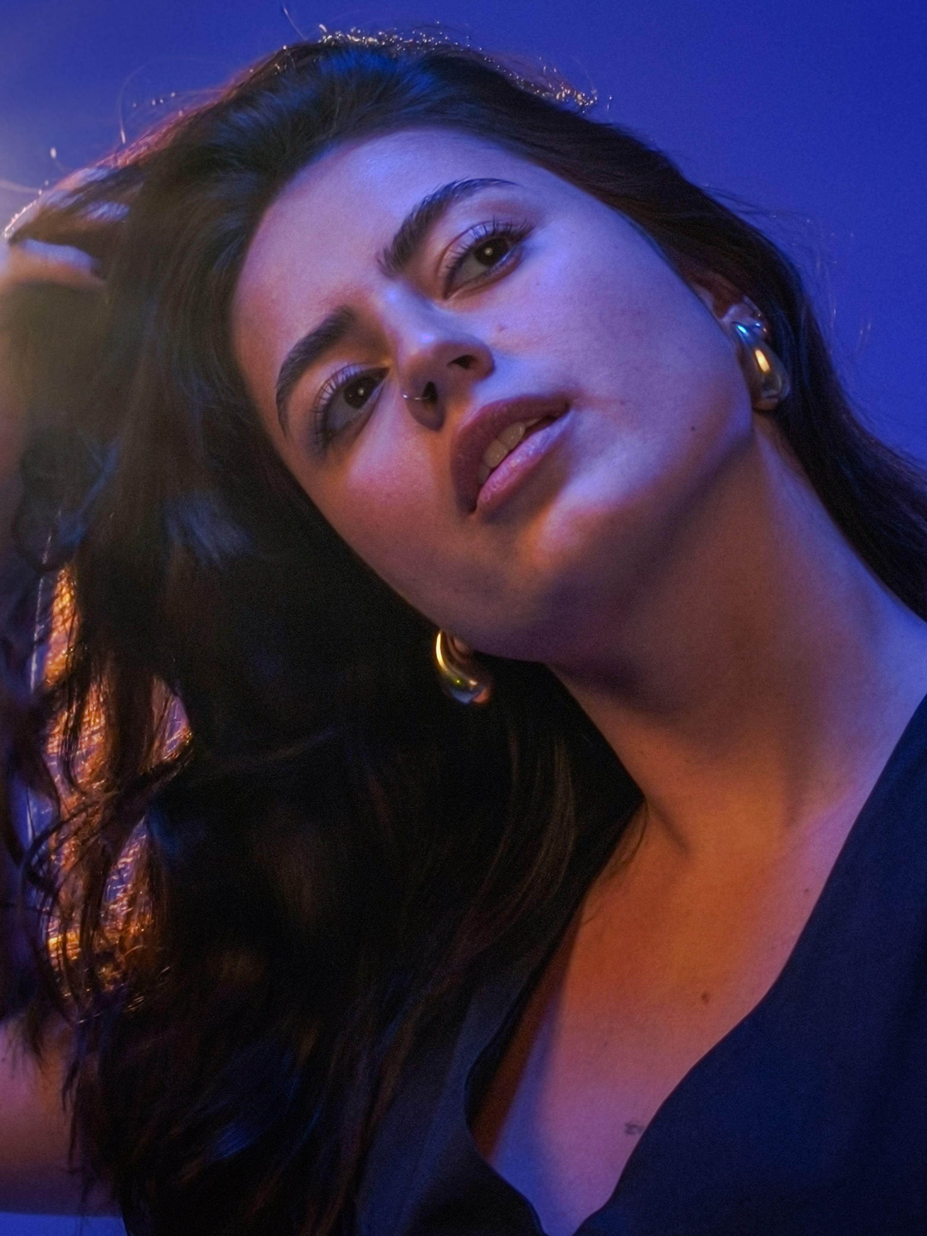 Portrait of a Woman Under Dramatic Lighting · Free Stock Photo