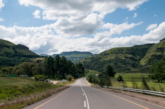 Captivating view of a highway winding through lush green hills in South Africa.