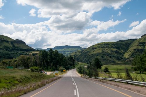 Free Captivating view of a highway winding through lush green hills in South Africa. Stock Photo