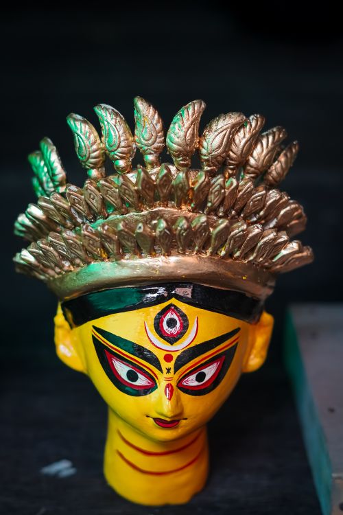 Free Colorful Durga idol head with intricate details at a Kolkata market. Perfect for festival themes. Stock Photo