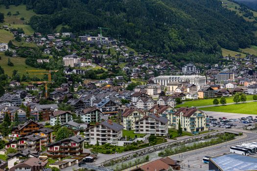 A beautiful aerial view of Engelberg, Switzerland showcasing charming houses and lush mountains.