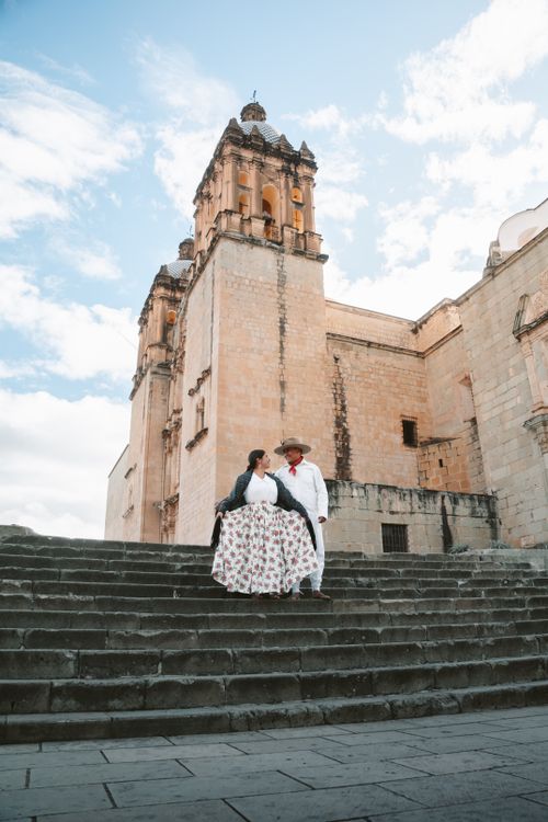 Free A couple in traditional attire at a historic church in Oaxaca, Mexico in daylight. Stock Photo