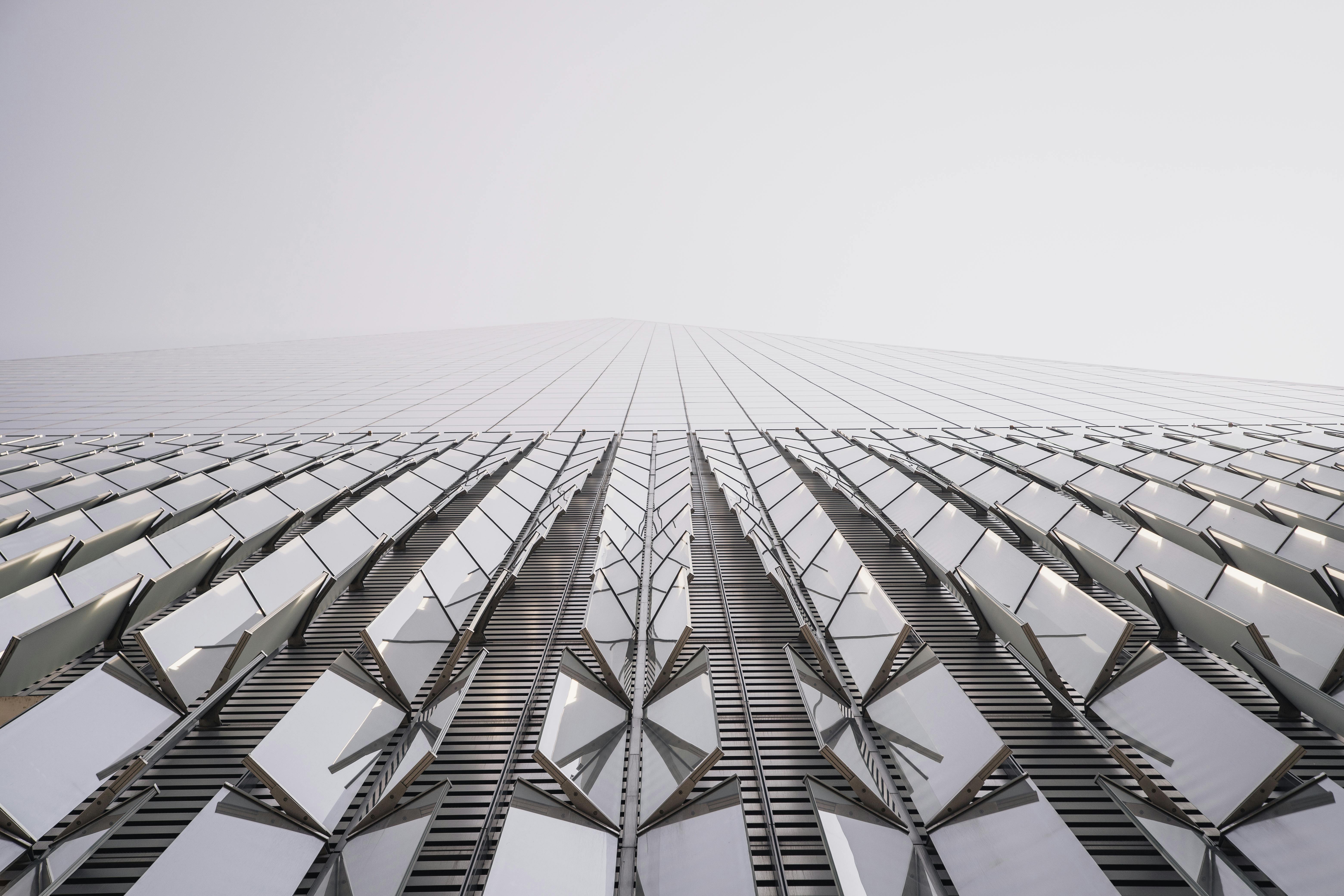 Low angle view of a modern skyscraper facade creating an abstract geometric pattern in New York City.