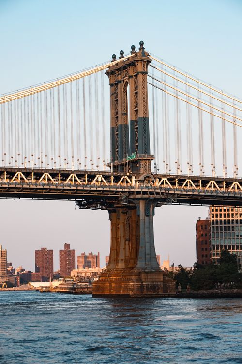 Free Scenic view of Manhattan Bridge spanning over East River in New York City during sunset. Stock Photo