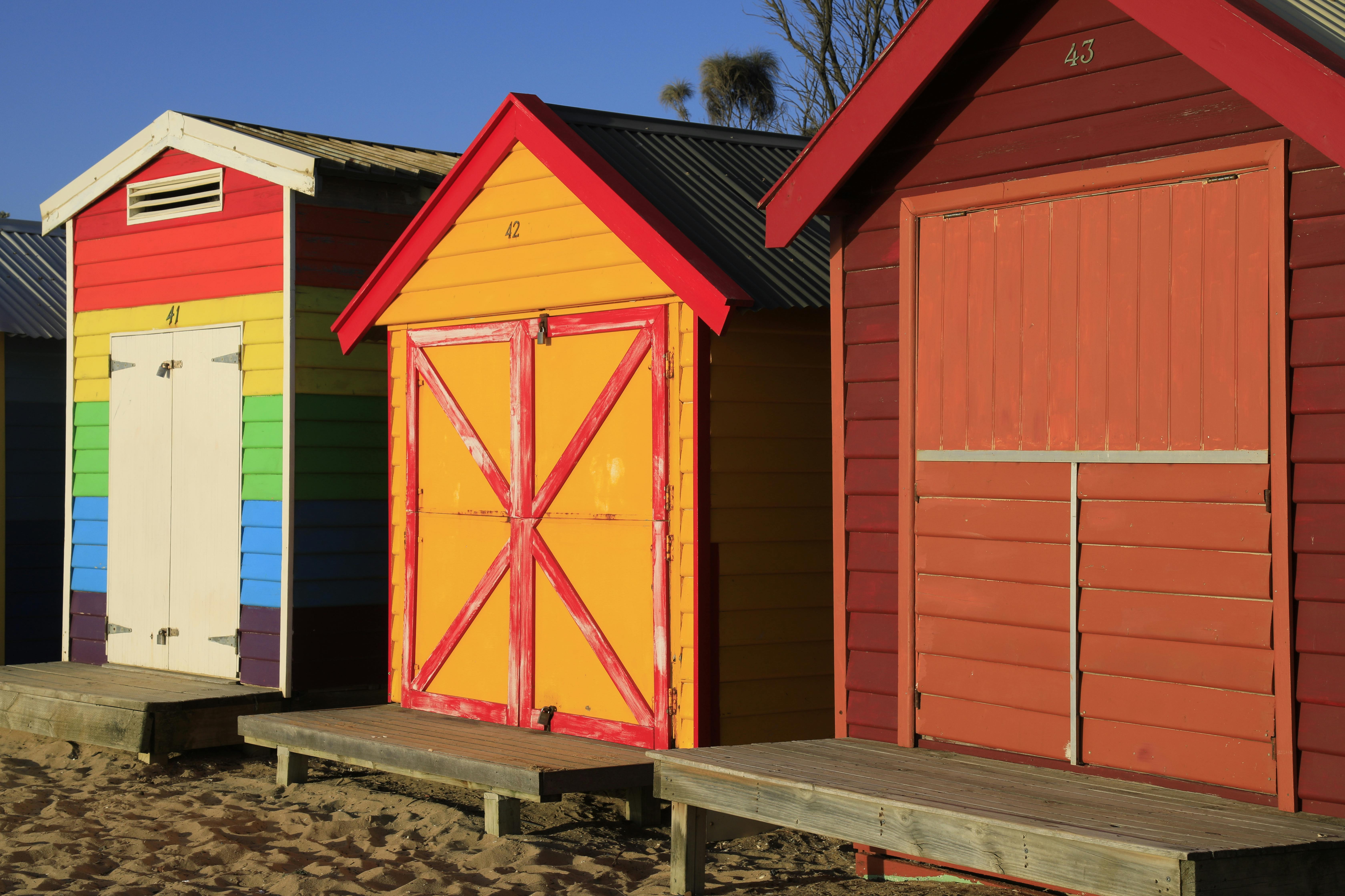 Vibrant beach huts on Brighton Beach, Melbourne, captured during golden hour.
