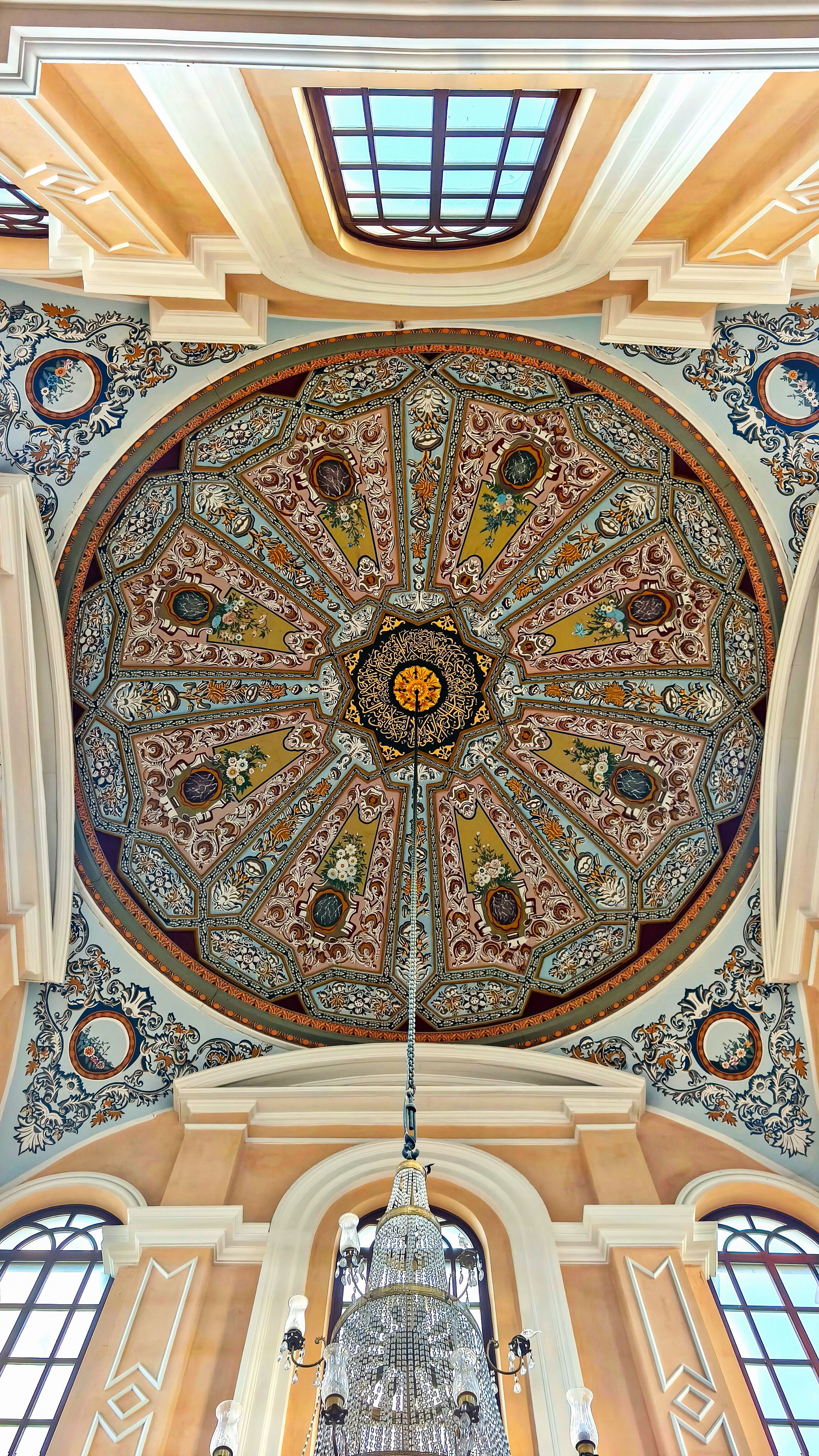 A stunning arabesque design graces the ceiling, showcasing the geometric precision, floral motifs, and potential incorporation of calligraphy inherent in this art form.