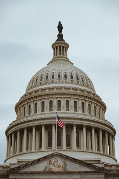 A captivating shot of the iconic US Capitol building dome in Washington, D.C. with the American flag.