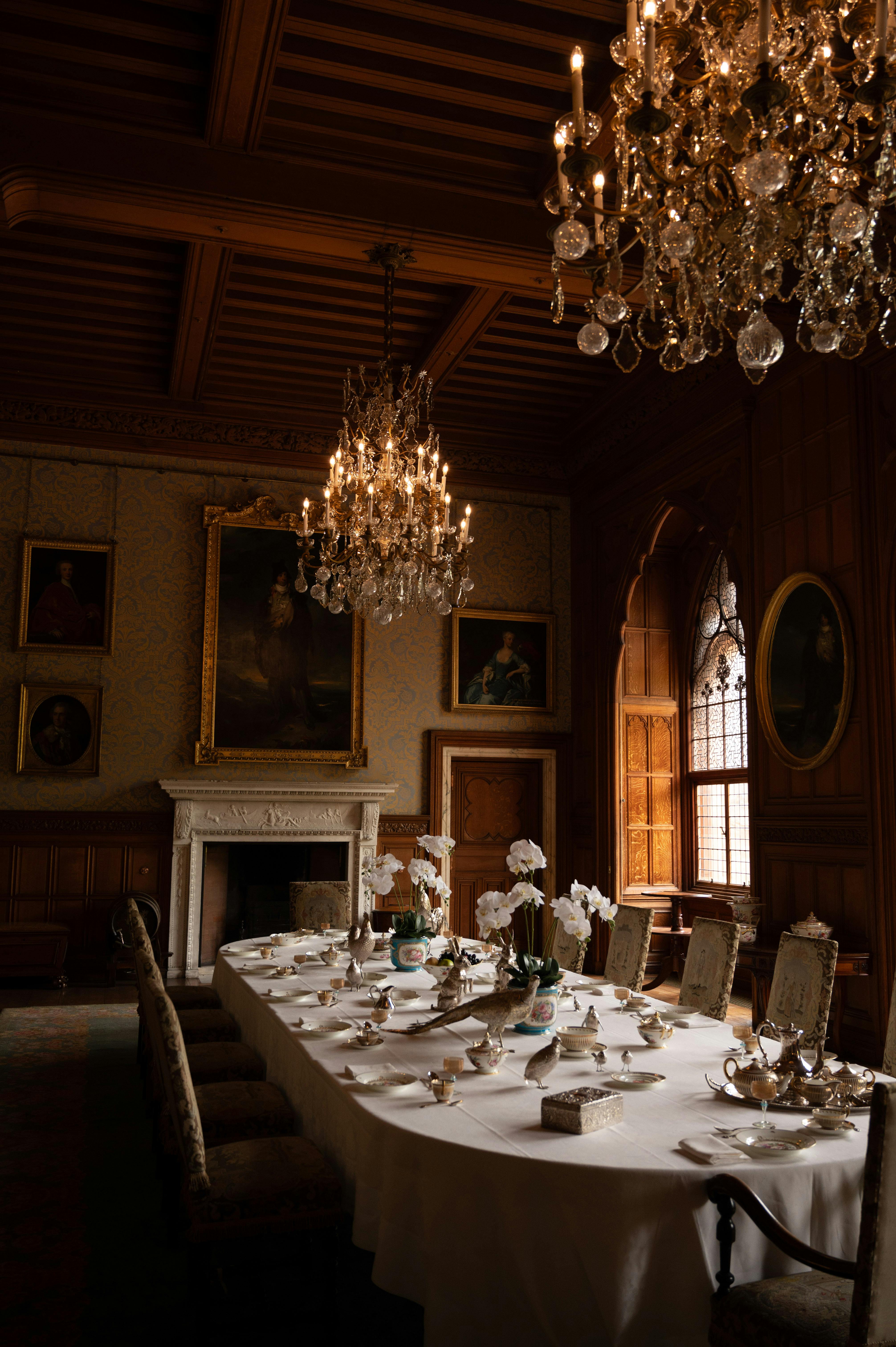 Explore the grandeur of a Neo-Gothic dining hall in Scotland, complete with chandeliers and historical portraits.