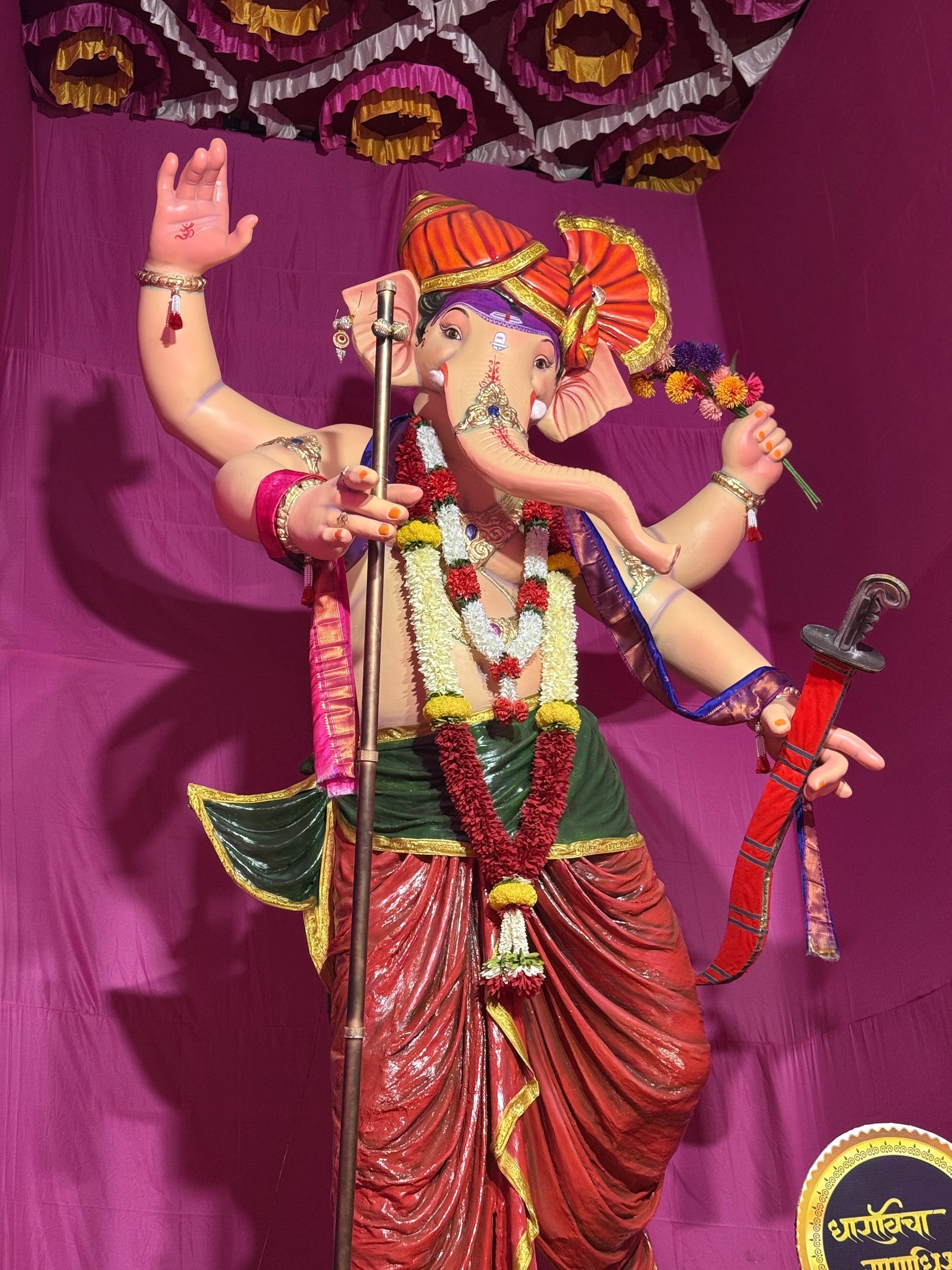 Colorful Ganesh idol adorned with flowers and ornaments, perfect for festivals.