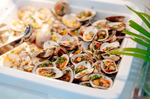 Free Savory grilled clams served at a Vietnamese seafood spot in Nha Trang. Stock Photo