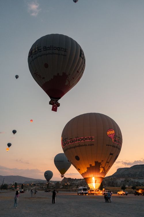 Free Hot air balloons ascending at sunrise over Cappadocia, Turkey, creating a mesmerizing landscape view. Stock Photo