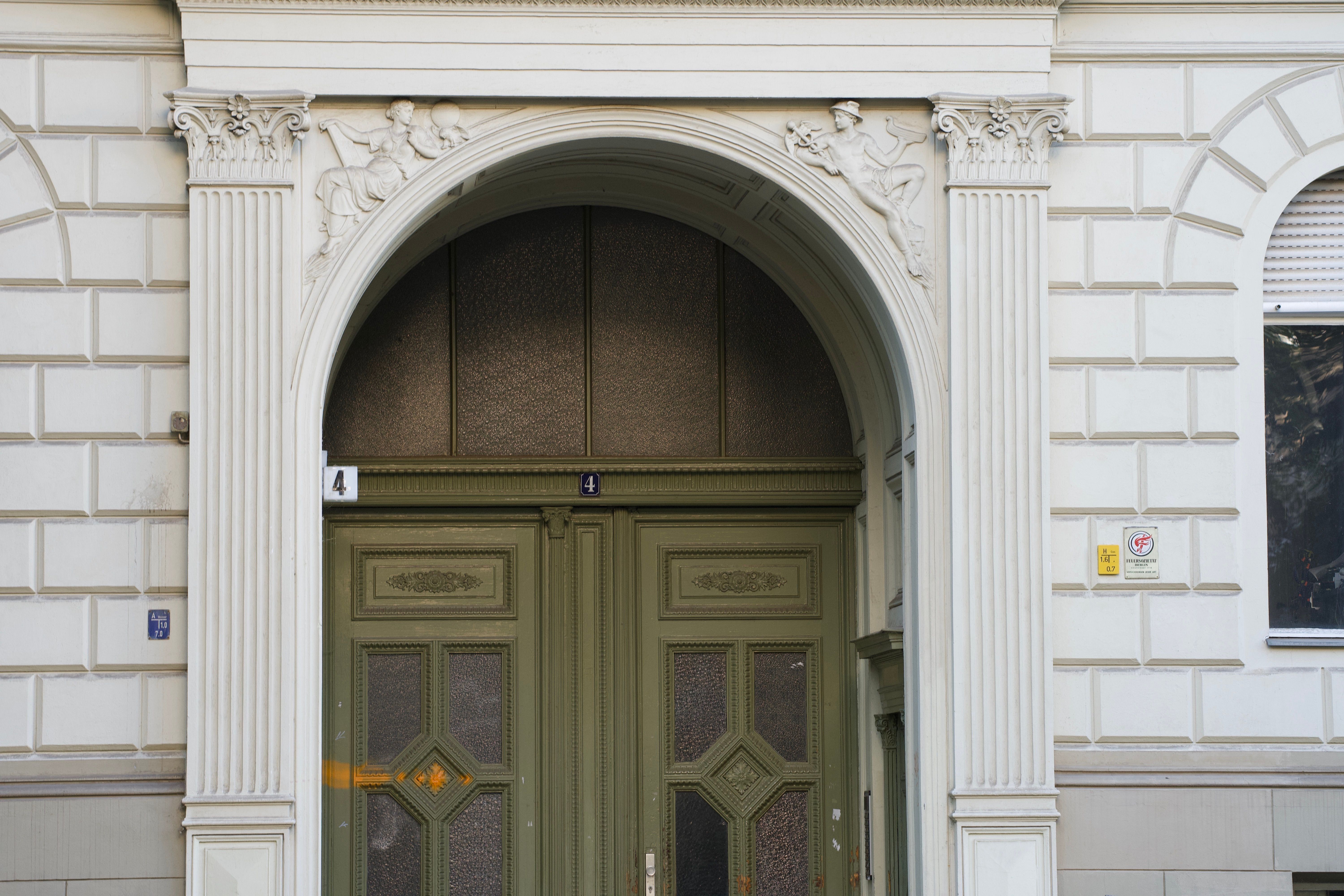 Ornate green entrance door with classical architectural details in Berlin. - Photo by Vinay Reddy Sama on Pexels