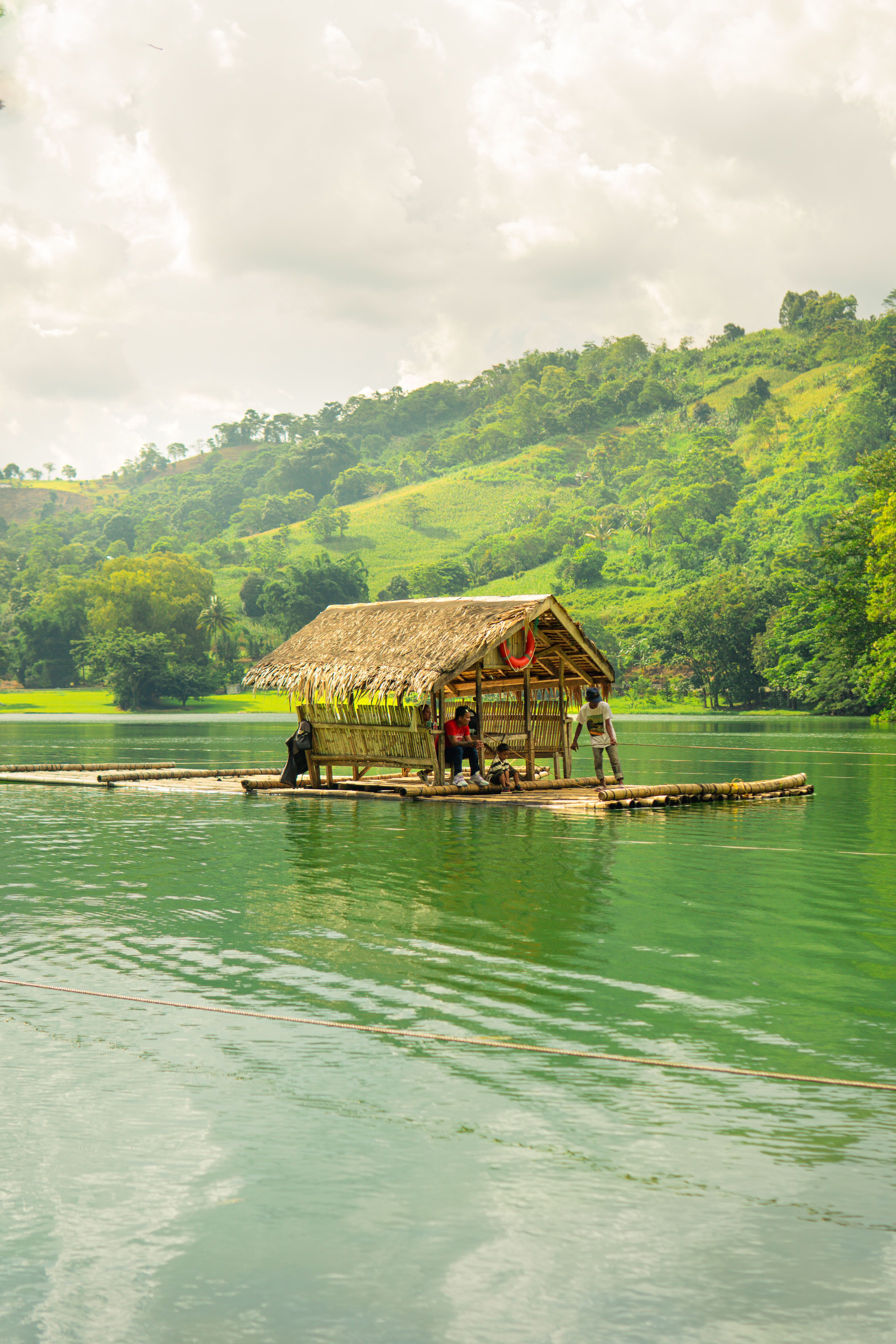 Rustic Bamboo Raft on Serene Tropical Lake · Free Stock Photo