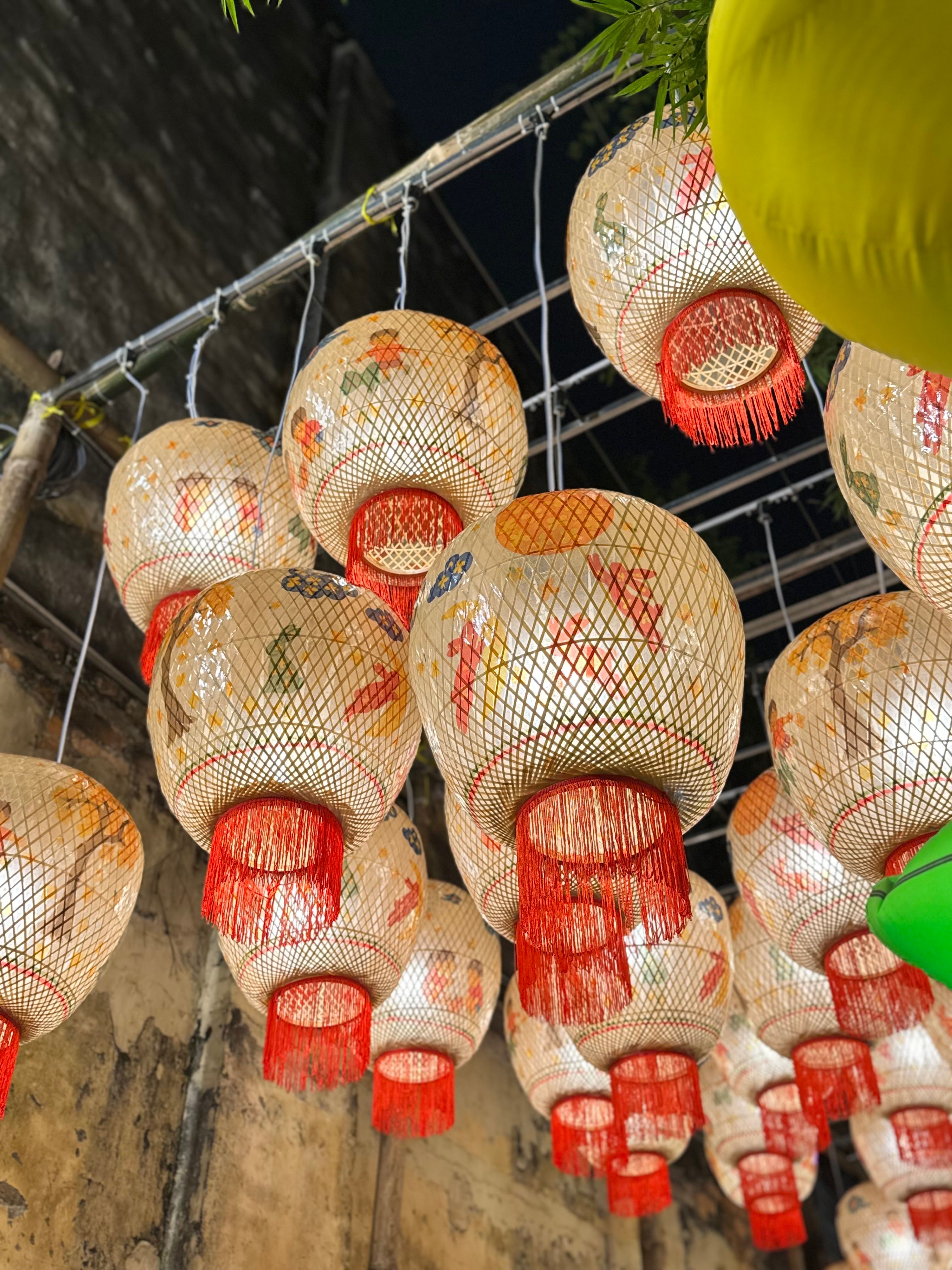Colorful traditional lanterns hanging, creating a vibrant night festival atmosphere.