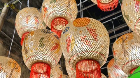 Colorful traditional lanterns hanging, creating a vibrant night festival atmosphere.