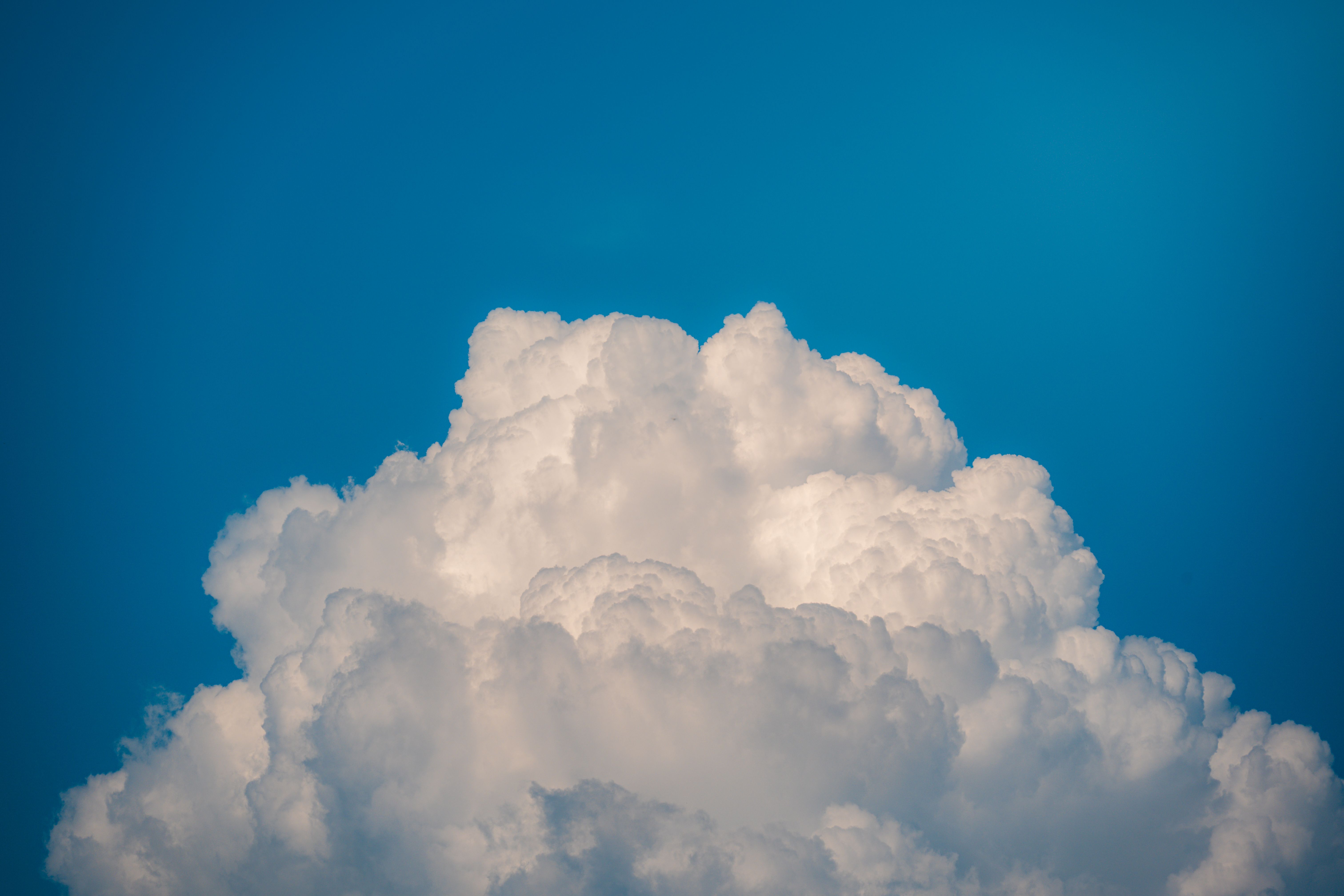 Fluffy White Clouds Against a Blue Sky · Free Stock Photo