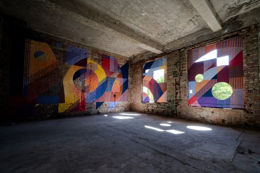 Colorful abstract murals adorn the walls of an old building in Chemnitz, Germany.