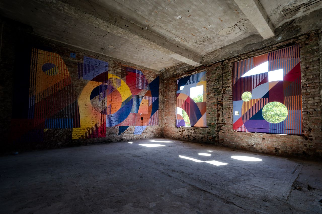 colorful abstract murals adorn the walls of an old building in chemnit